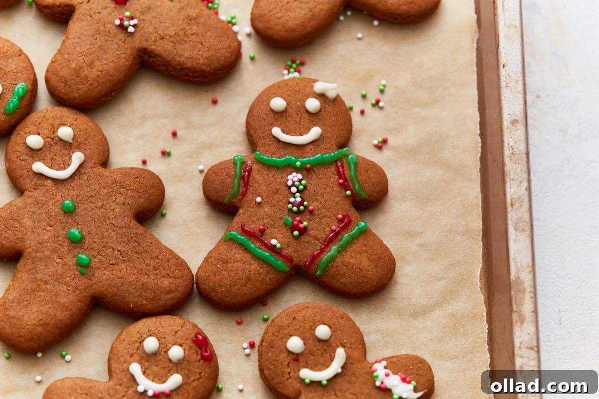 Gluten Free Gingerbread Delights 4 Overhead view of several beautifully decorated gluten-free gingerbread cookies, adorned with festive sprinkles and icing, ready for holiday celebrations.