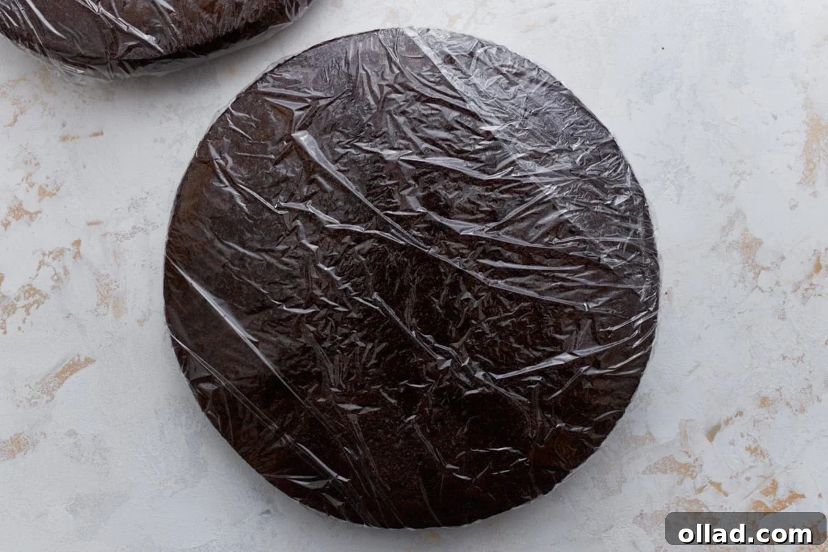 Decadent Gluten-Free Ice Cream Cake 13 Two chocolate cake layers wrapped tightly in plastic wrap, ready to be frozen before assembling the cake.