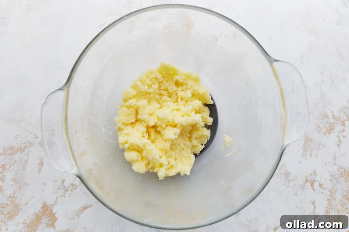 Decadent Gluten-Free Ice Cream Cake 8 A glass mixing bowl with softened butter and granulated sugar creamed together.