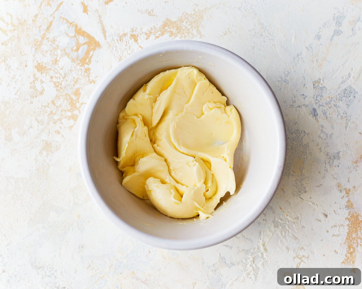 Irresistible Gluten-Free Cinnamon Rolls 11 softened butter in a white bowl.