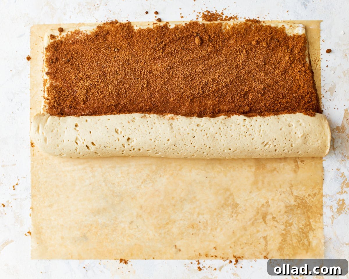 Irresistible Gluten-Free Cinnamon Rolls 16 rolling up gluten-free cinnamon roll dough.