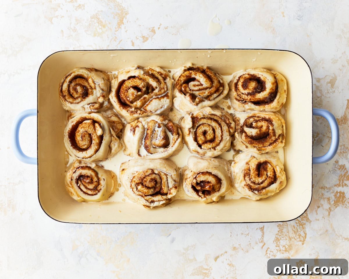 Irresistible Gluten-Free Cinnamon Rolls 18 cinnamon rolls arranged in a baking tray.