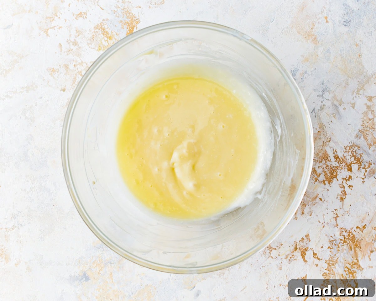 Irresistible Gluten-Free Cinnamon Rolls 20 wet ingredients in a glass bowl.