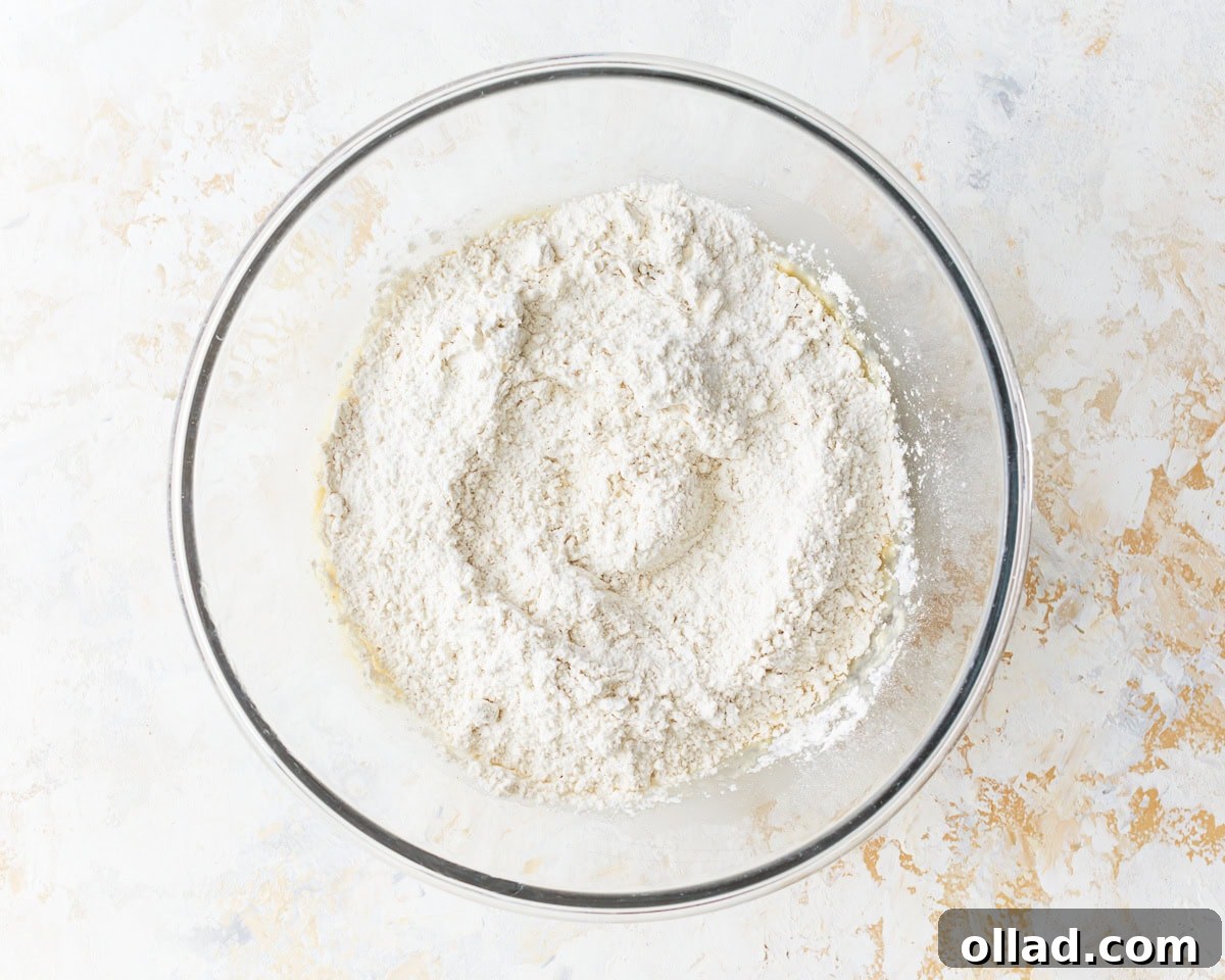 Irresistible Gluten-Free Cinnamon Rolls 7 flour in a glass bowl.