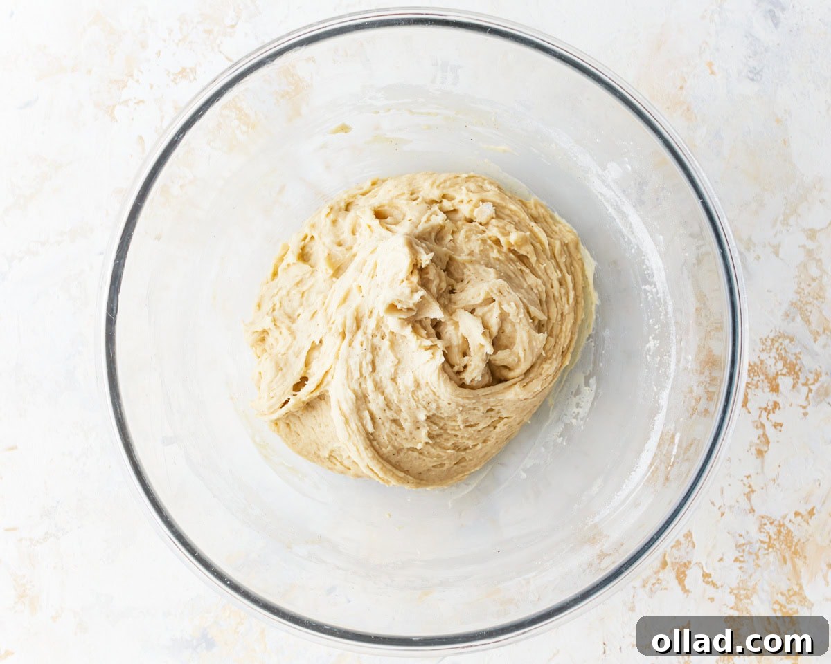 Irresistible Gluten-Free Cinnamon Rolls 8 gluten-free dough in a glass bowl.
