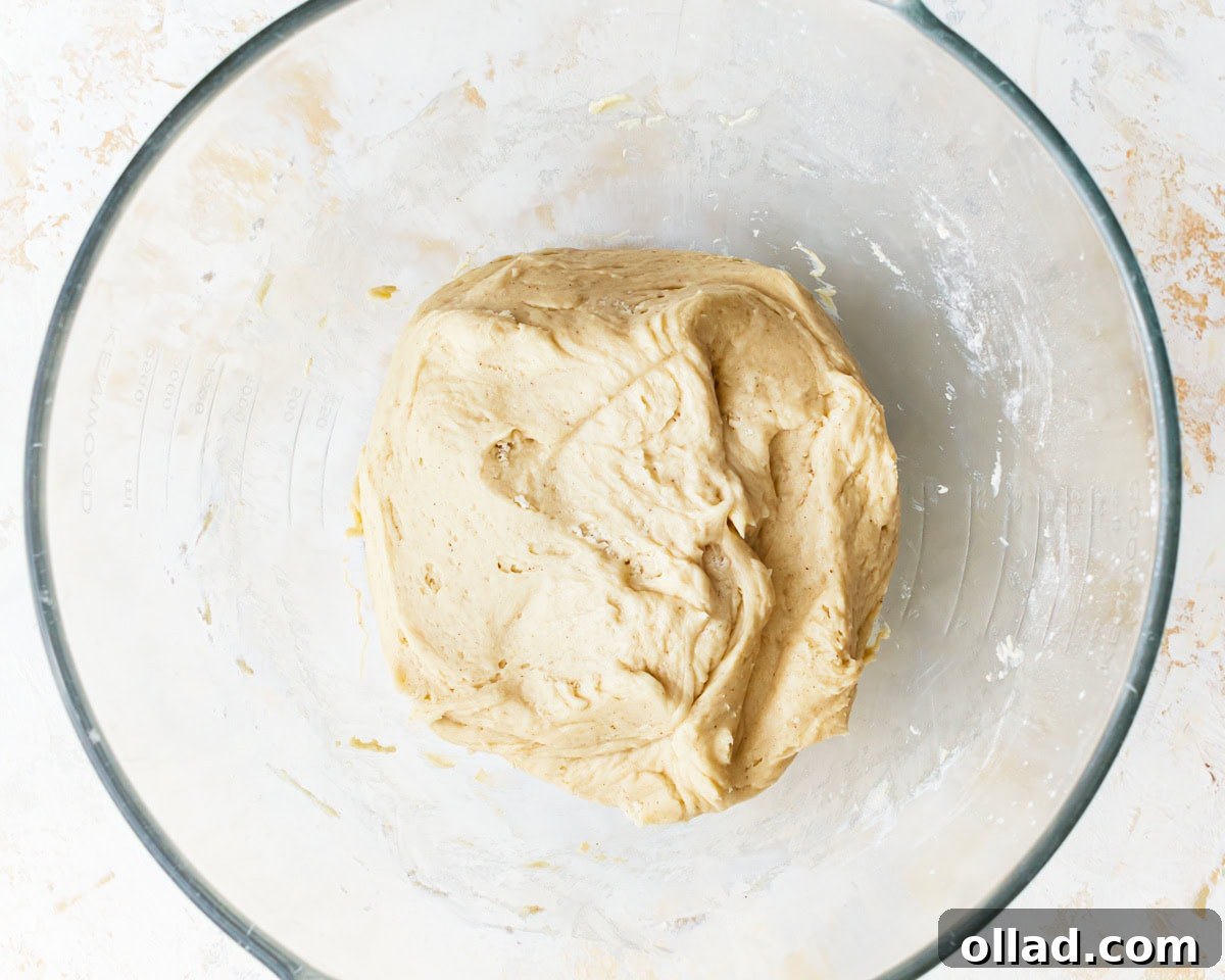 Irresistible Gluten-Free Cinnamon Rolls 9 kneaded gluten-free dough in a glass bowl.