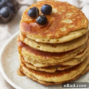 A stack of delicious almond flour pancakes with blueberries and syrup