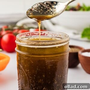 A jar of gluten-free balsamic vinaigrette with a spoon.