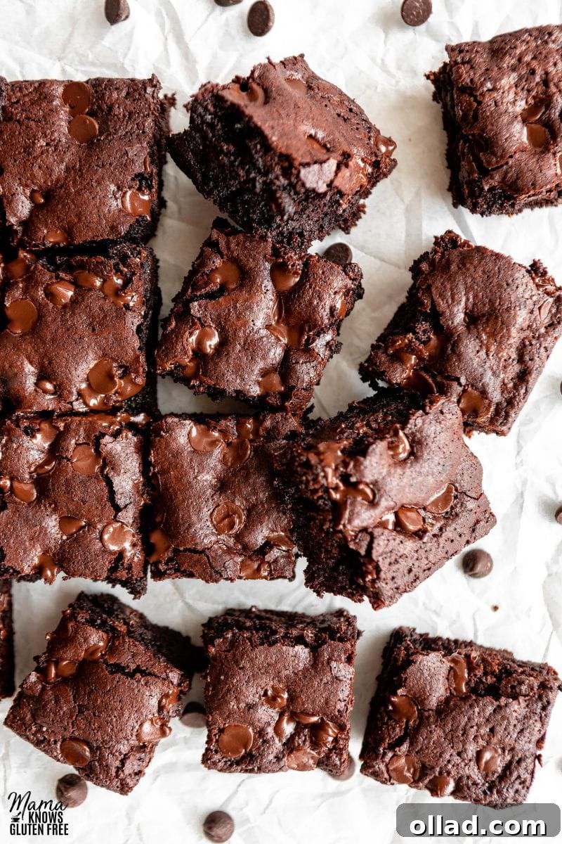 Decadent Almond Flour Fudge Brownies 2 Cut up square of Almond Flour Brownies on parchment paper.