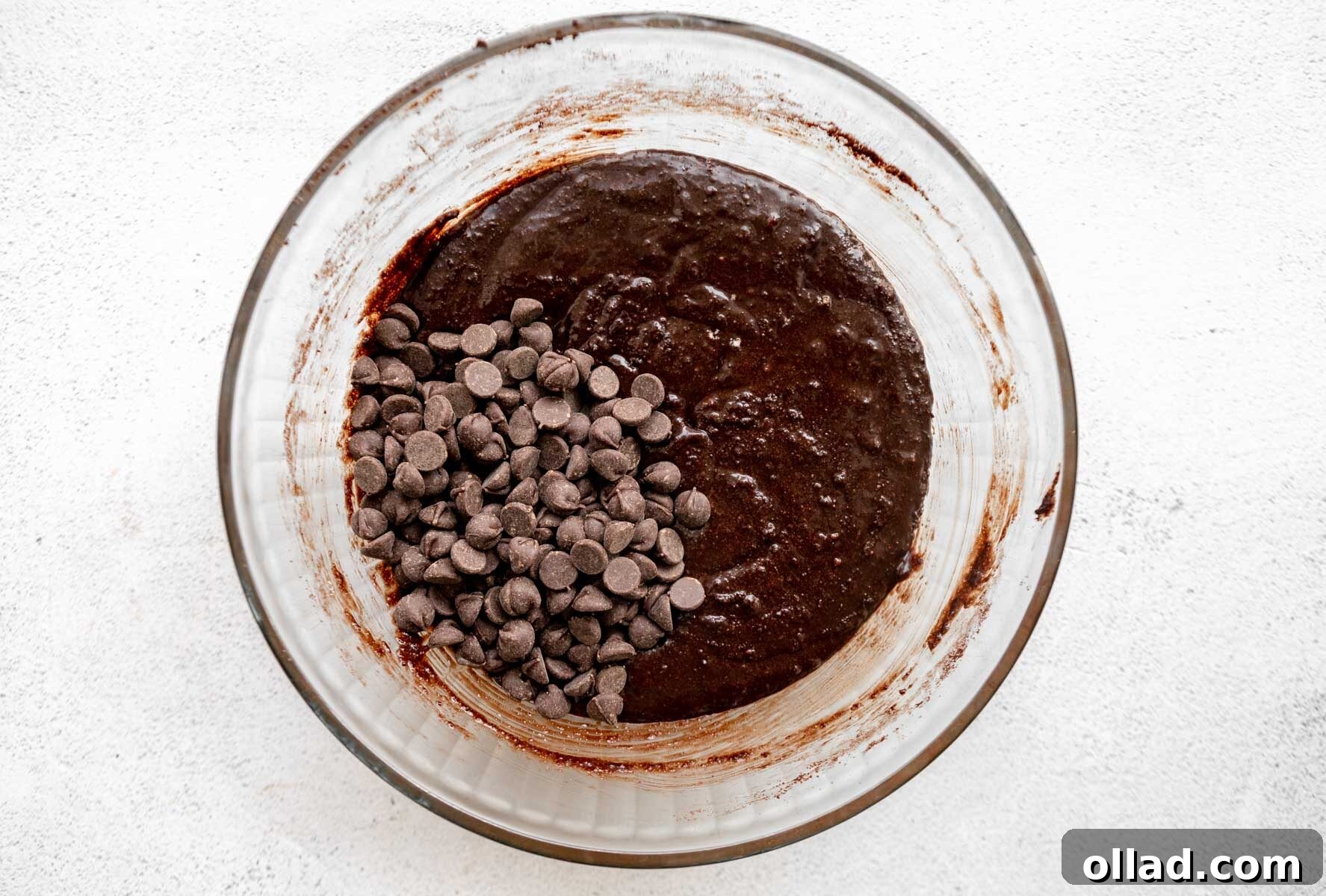 Decadent Almond Flour Fudge Brownies 8 Almond flour brownie batter with chocolate chips in a glass mixing bowl.