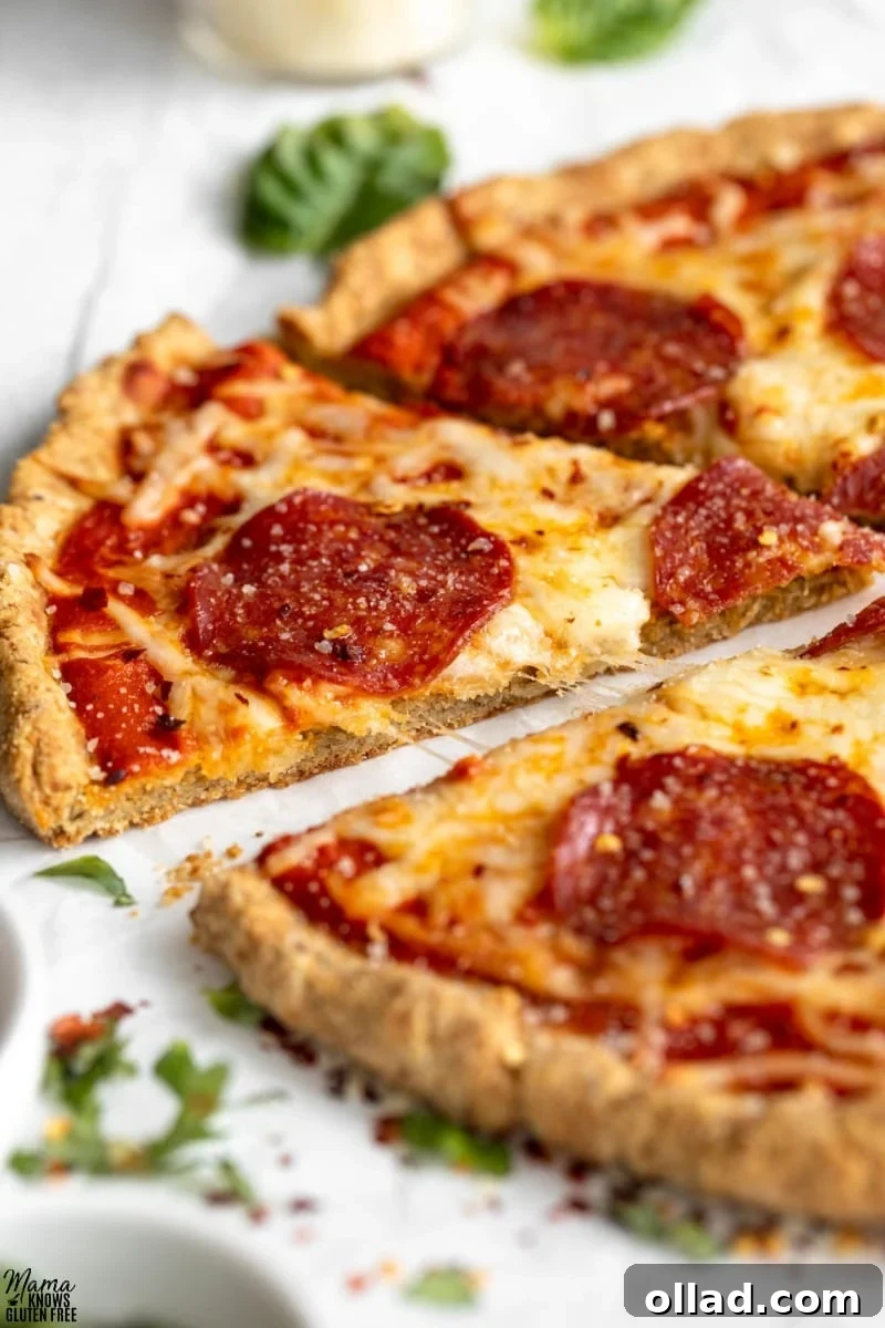 Close up of a delicious slice of pizza made using a Gluten-Free Almond Flour Pizza Crust, ready to be enjoyed.