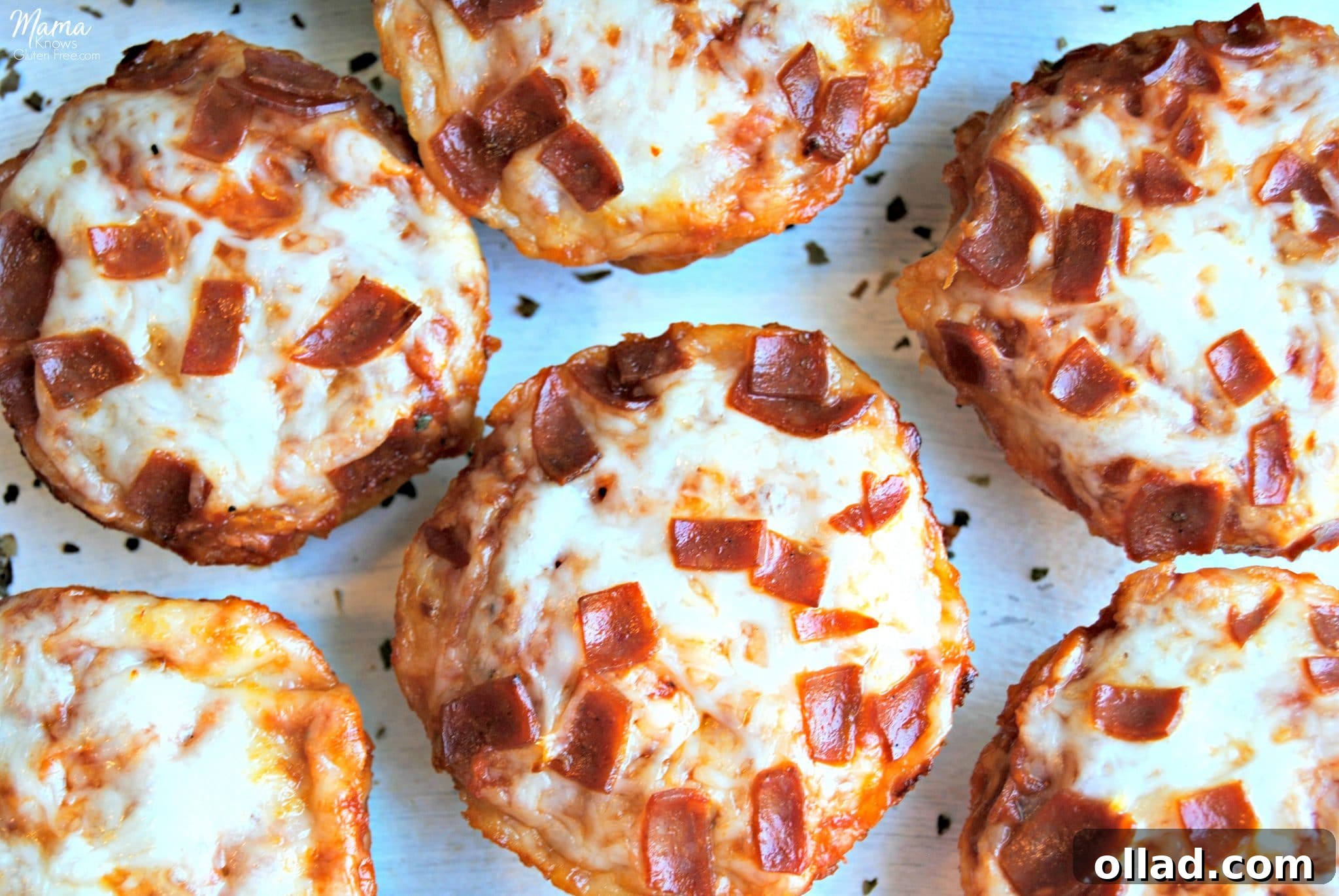 A vibrant overhead shot of freshly baked gluten-free deep dish pizza bites, showcasing their golden crusts, melted cheese, and various appetizing toppings.