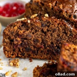 A slice of Gluten-Free Fruit Cake with candied cherries and nuts.