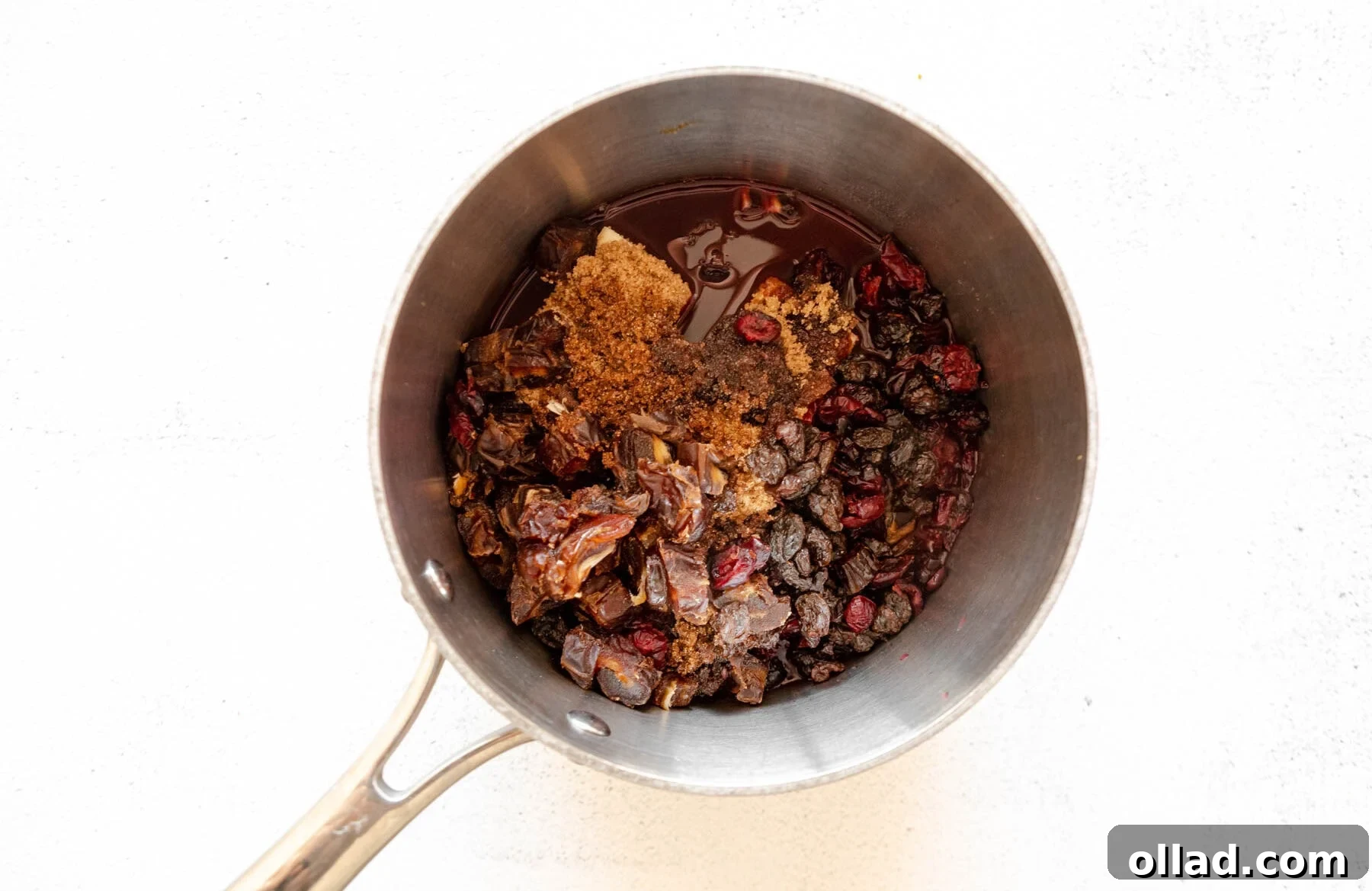 Deliciously Flourless Fruitcake 7 Dried fruit, butter, sugar, orange zest, and brandy simmering in a sauce pan.