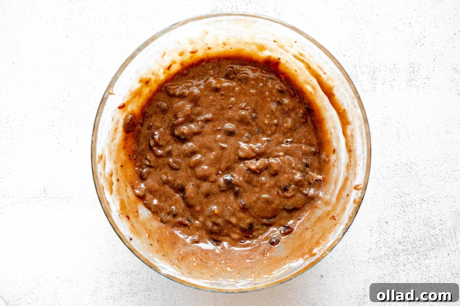 Deliciously Flourless Fruitcake 9 Gluten-free fruit cake batter in a glass mixing bowl after dry ingredients are added.