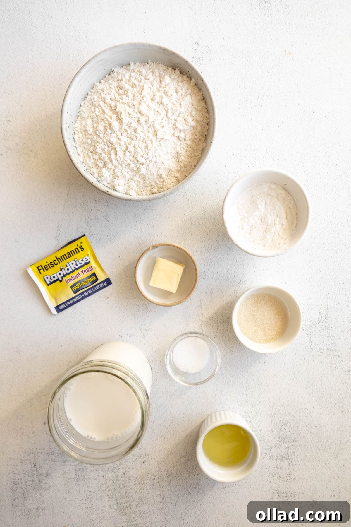 Individual bowls containing all the gluten-free English muffin ingredients laid out on a table.