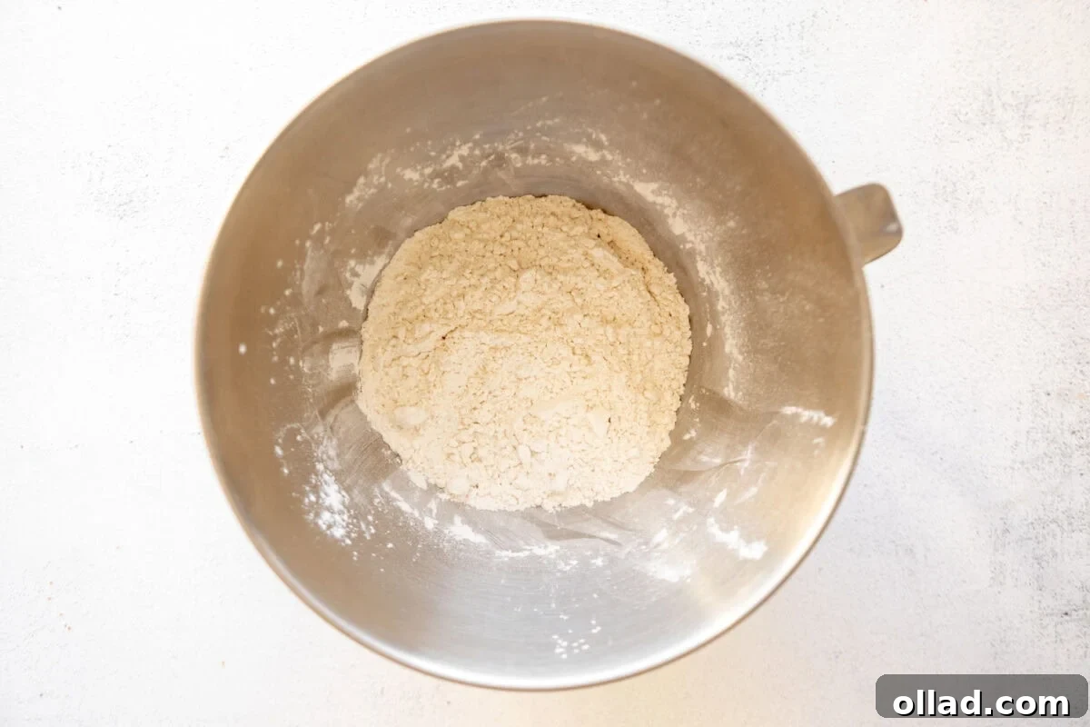 Flour in a stainless mixing bowl, ready for combining with other ingredients.