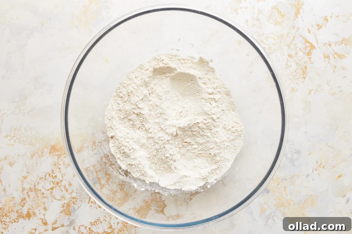 All dry ingredients for gluten-free crescent rolls pre-measured in a glass bowl.