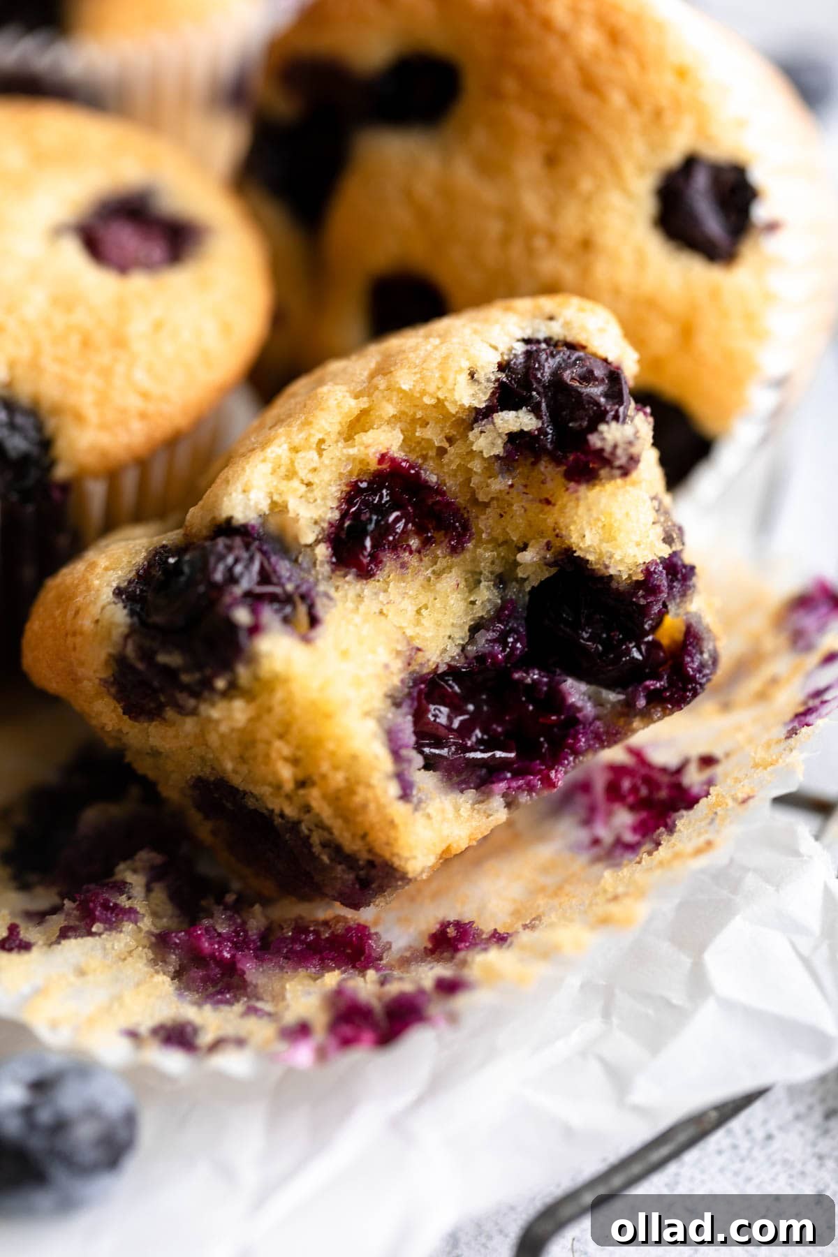 close-up view of a bitten almond flour blueberry muffin.