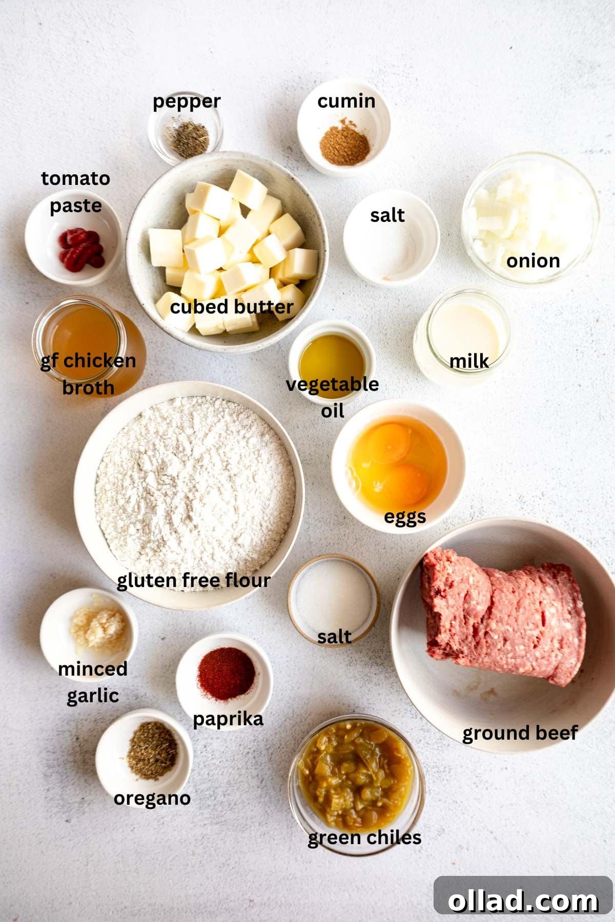 All the fresh ingredients laid out on a wooden board, ready to be prepared for the gluten-free empanada dough and savory beef filling.