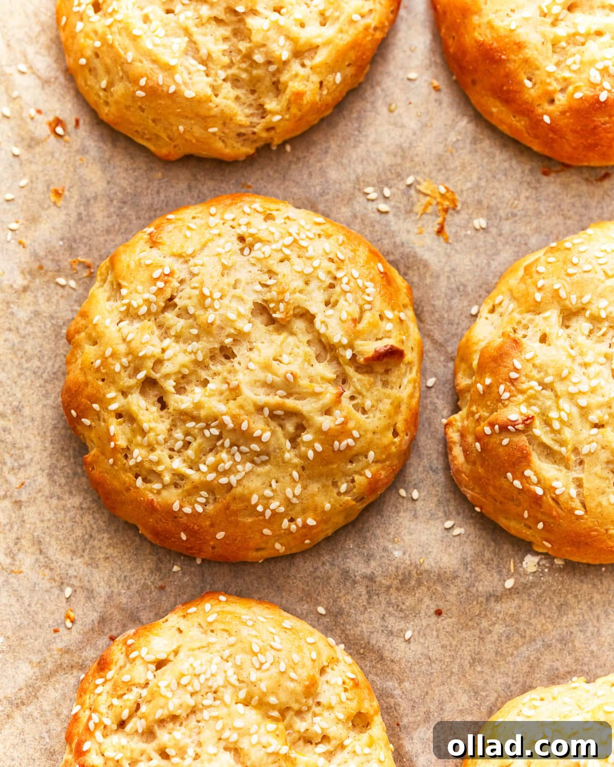 overhead view of gluten-free hamburger buns on parchment.