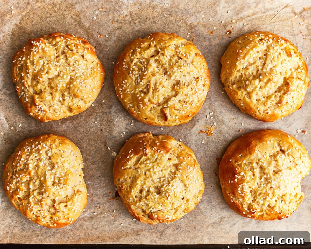 baked gluten-free hamburger buns on a baking sheet.