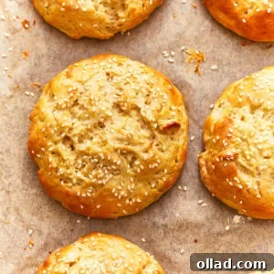 overhead view of gluten-free hamburger buns on parchment.
