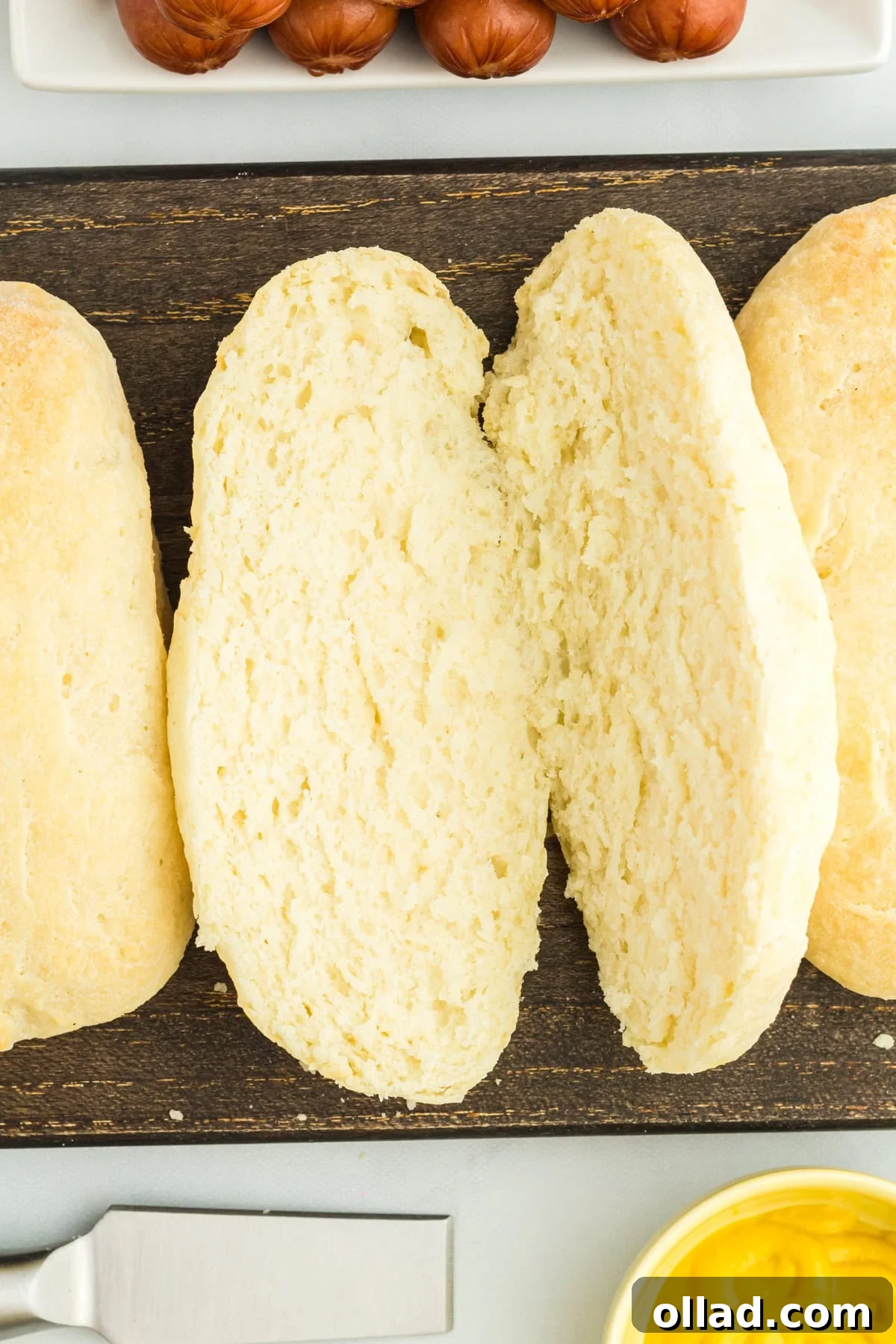 close-up overhead view of a cut gluten-free hot dog bun, showcasing its fluffy texture.