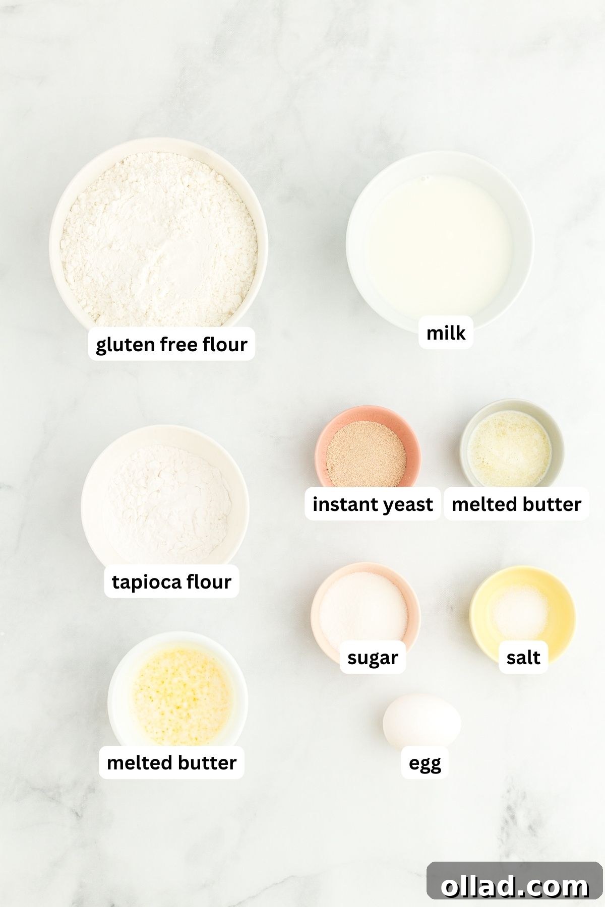 Various ingredients for gluten-free hot dog buns laid out on a wooden surface.