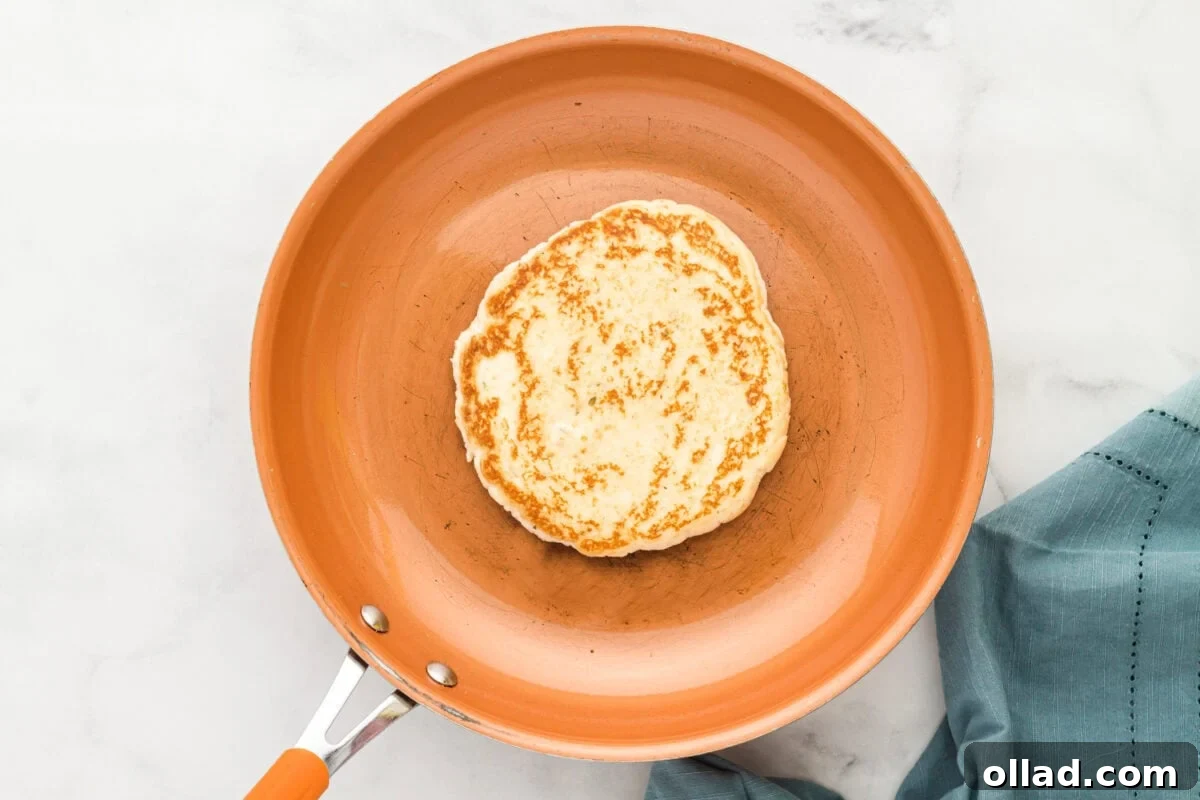 Pillowy Gluten-Free Flatbread 9 gluten-free flatbread browned in an orange skillet