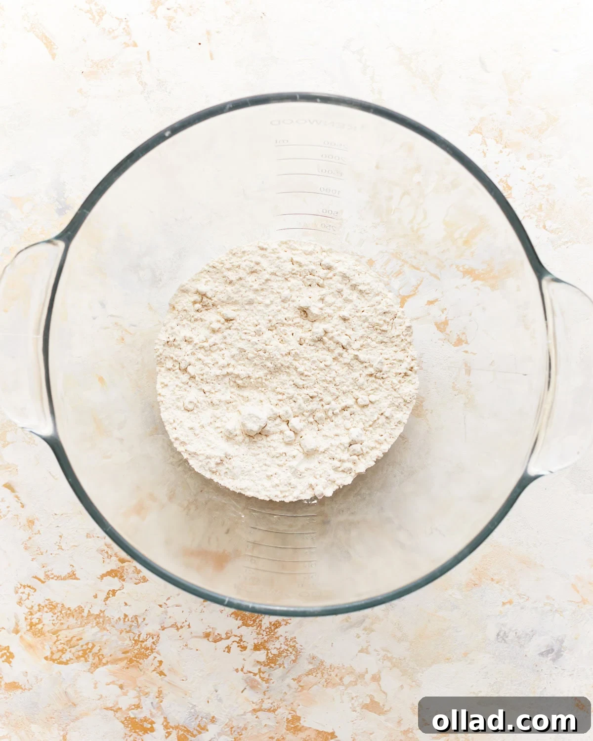 Gluten-free flour, xanthan gum, and sea salt in a glass mixing bowl.