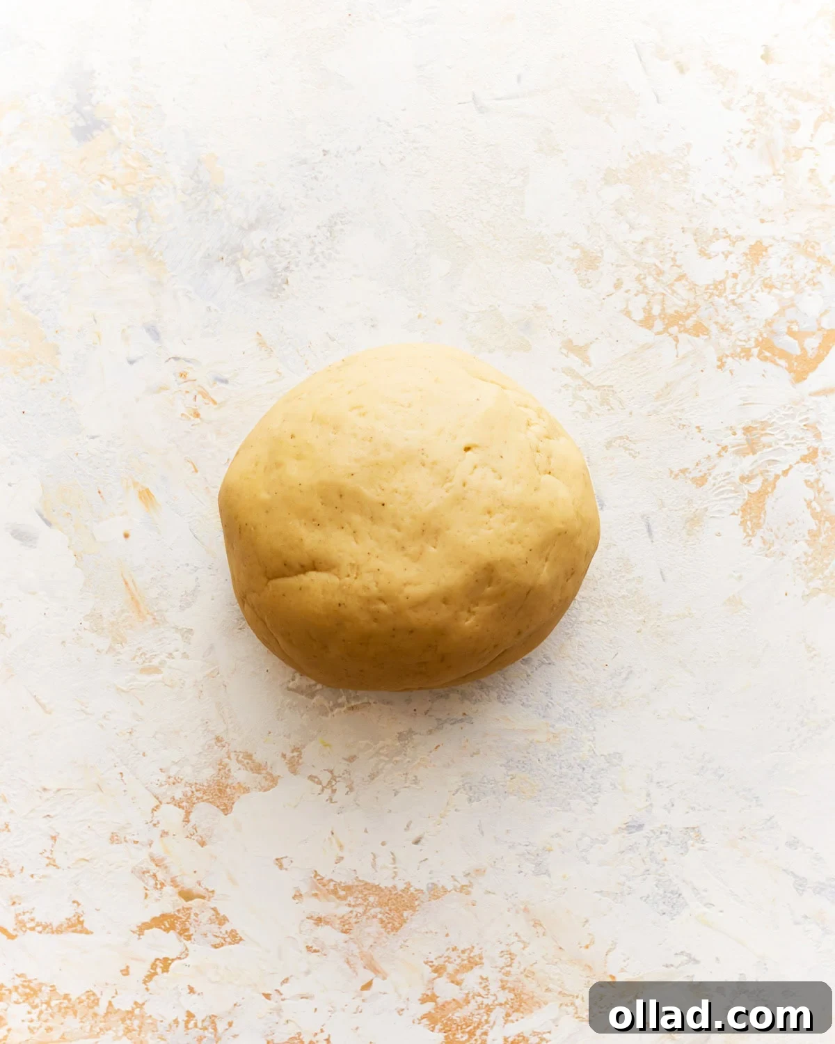 A smooth, kneaded gluten-free pasta dough ball.