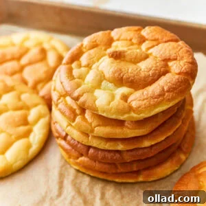 Overhead view of a stack of cloud bread on a parchment lined baking sheet.
