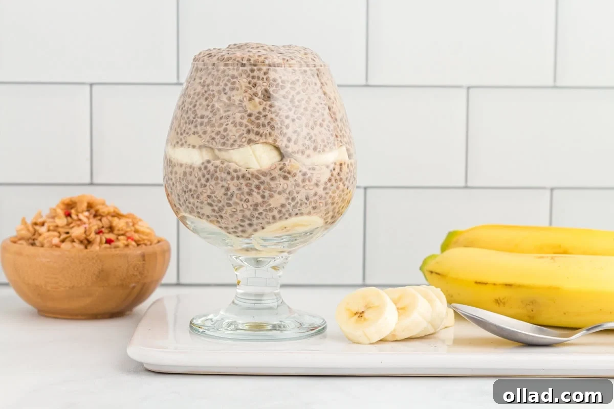 side view of banana chia pudding in a stemmed glass.