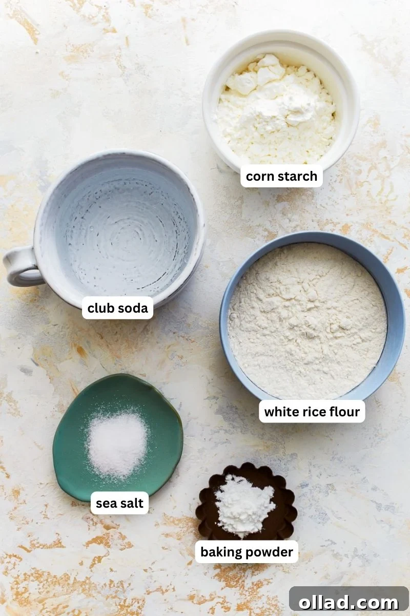 Ingredients for making gluten free tempura batter arranged on a surface.