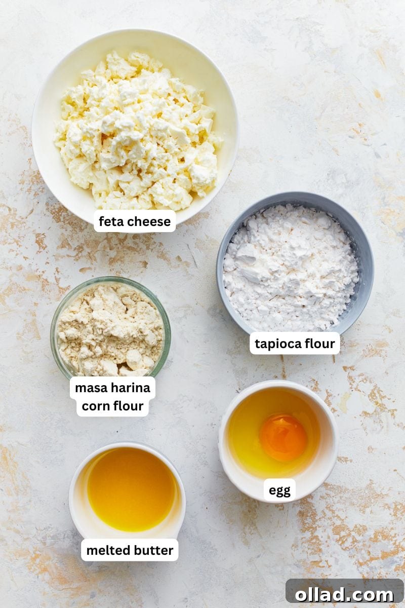 All five ingredients for making Pandebono Colombian cheese bread: tapioca flour, masa harina, feta cheese, an egg, and melted butter.