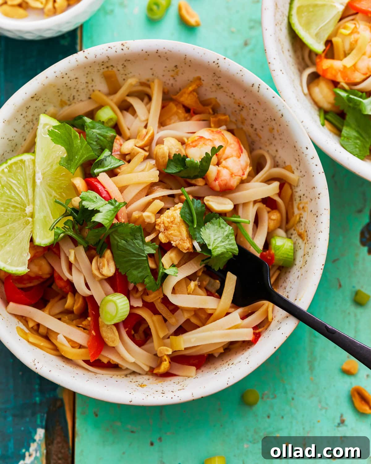 Gluten-free pad thai in a bowl with a fork