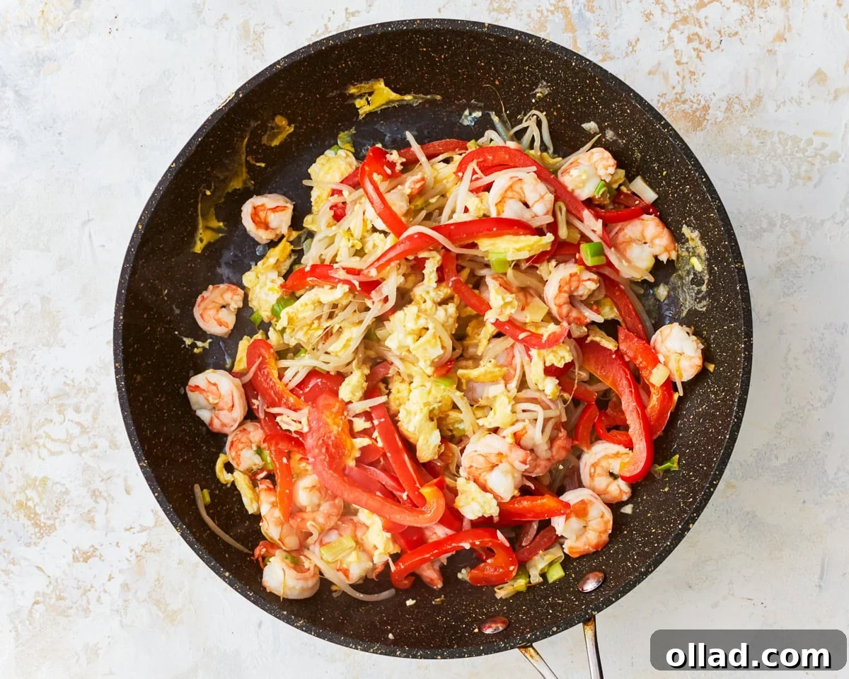 Eggs mixed with vegetables and shrimp for gluten-free pad thai