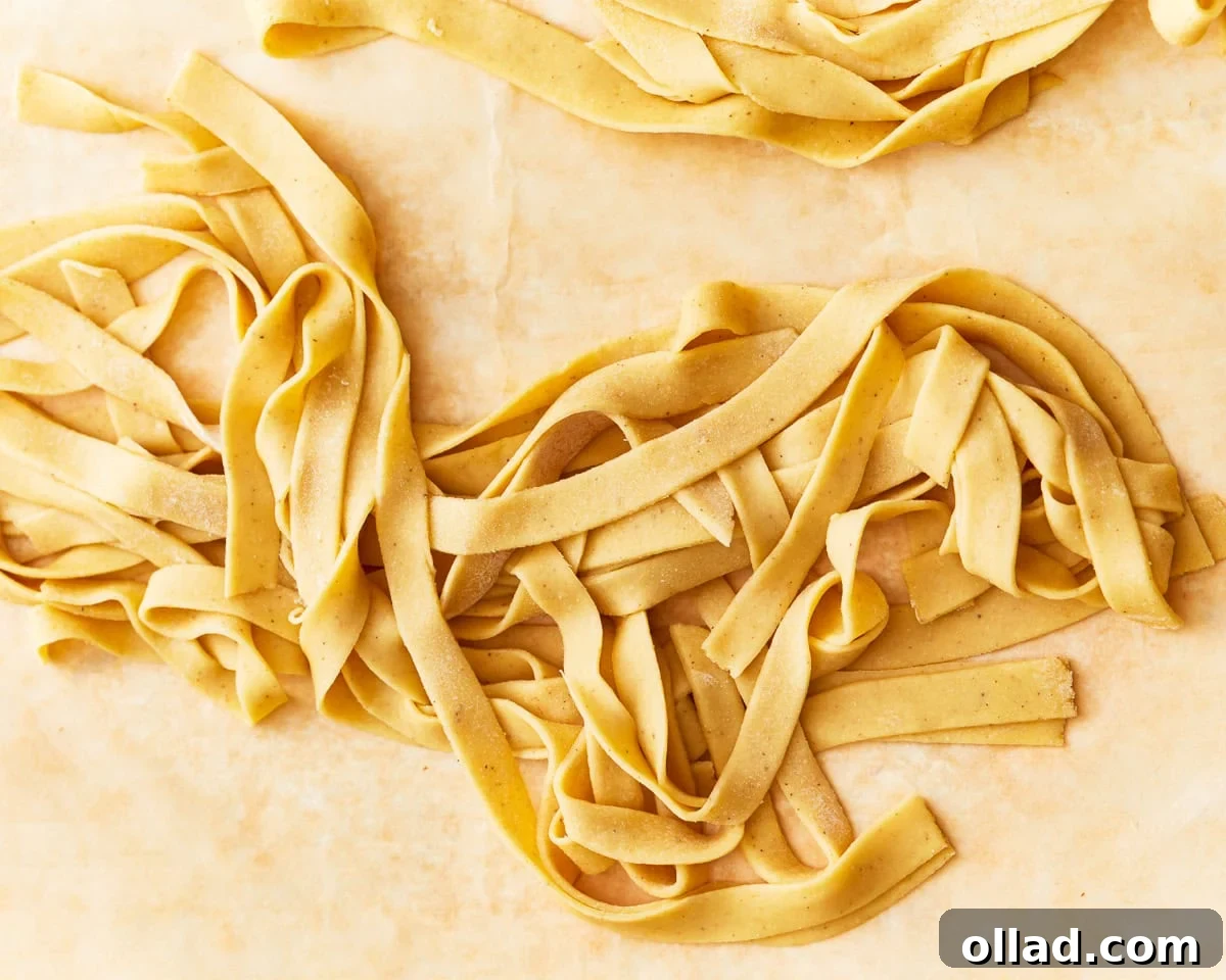 Freshly cooked gluten-free egg noodles, perfectly al dente, drained and ready for serving.