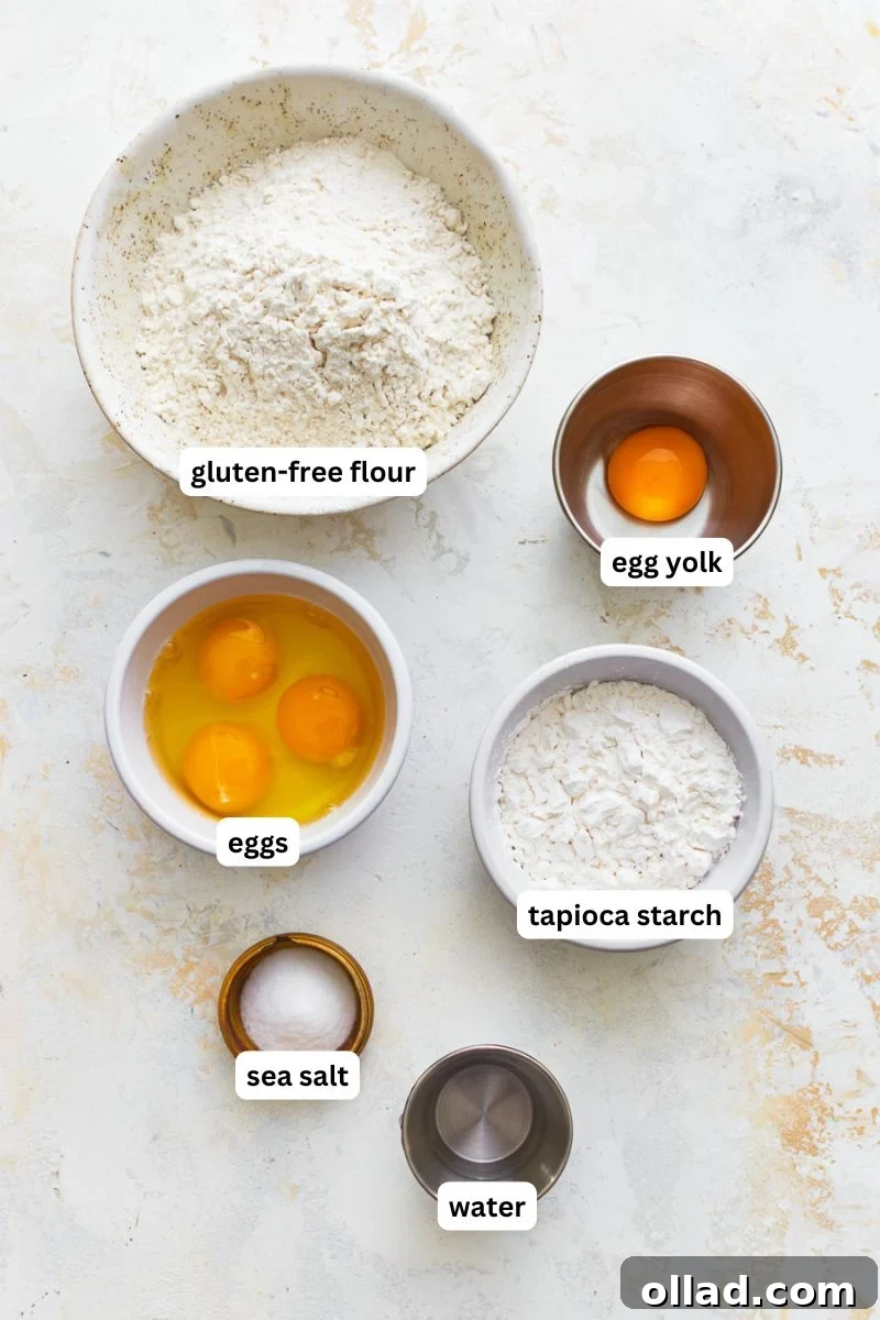 All the essential ingredients for homemade gluten-free egg noodles carefully laid out on a clean surface, ready for mixing.