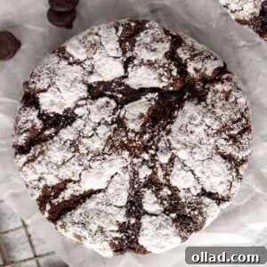 gluten-free chocolate crinkle cookies on white parchment paper