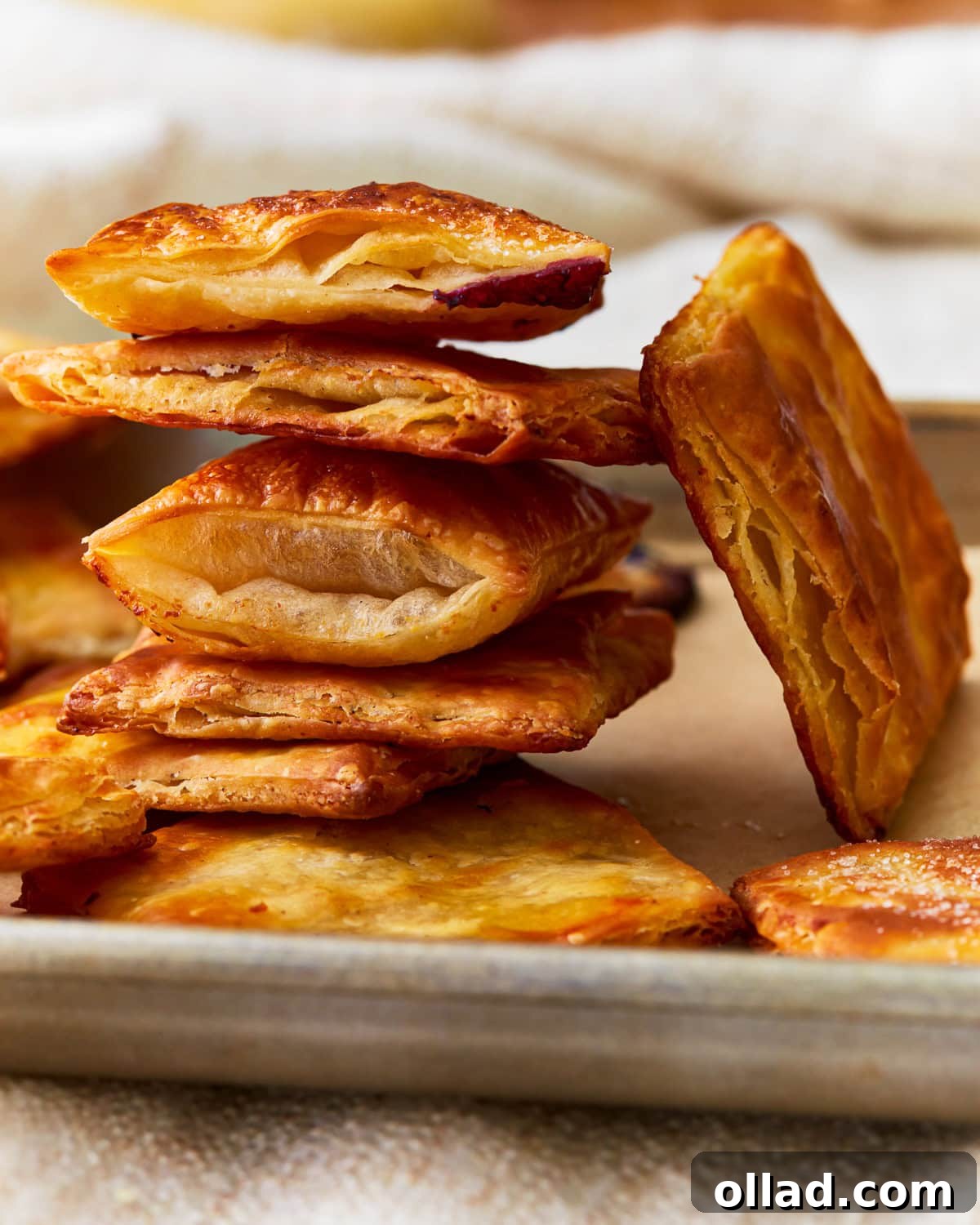 Unbelievably Flaky Gluten-Free Puff Pastry 2 Stacked squares of golden, flaky gluten-free puff pastry, ready for your favorite treats.