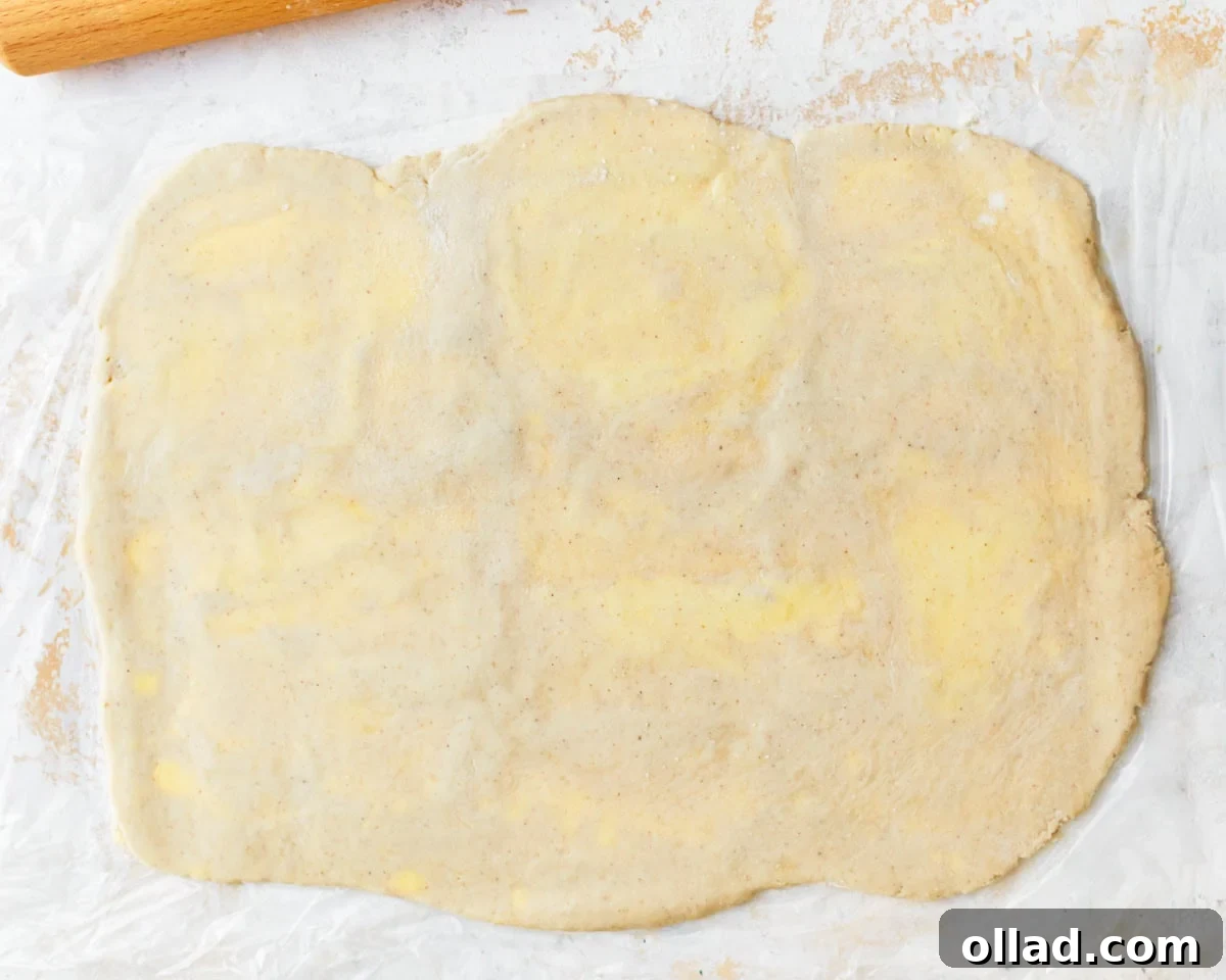 Unbelievably Flaky Gluten-Free Puff Pastry 14 Rolled out puff pastry dough showing flecks of butter visibly distributed throughout the dough, indicating proper lamination.