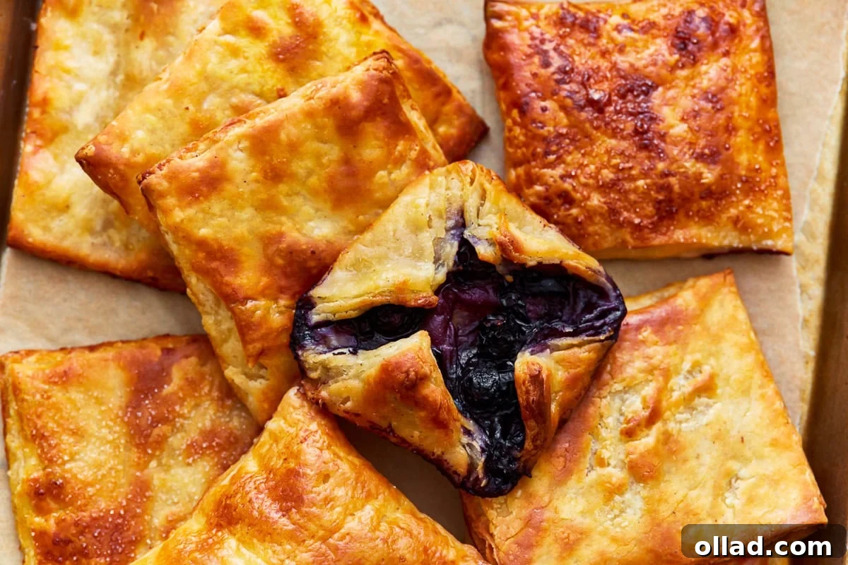 Unbelievably Flaky Gluten-Free Puff Pastry 19 A spread of baked gluten-free puff pastry squares alongside a beautifully crafted Danish pastry, showcasing the versatility of the dough.