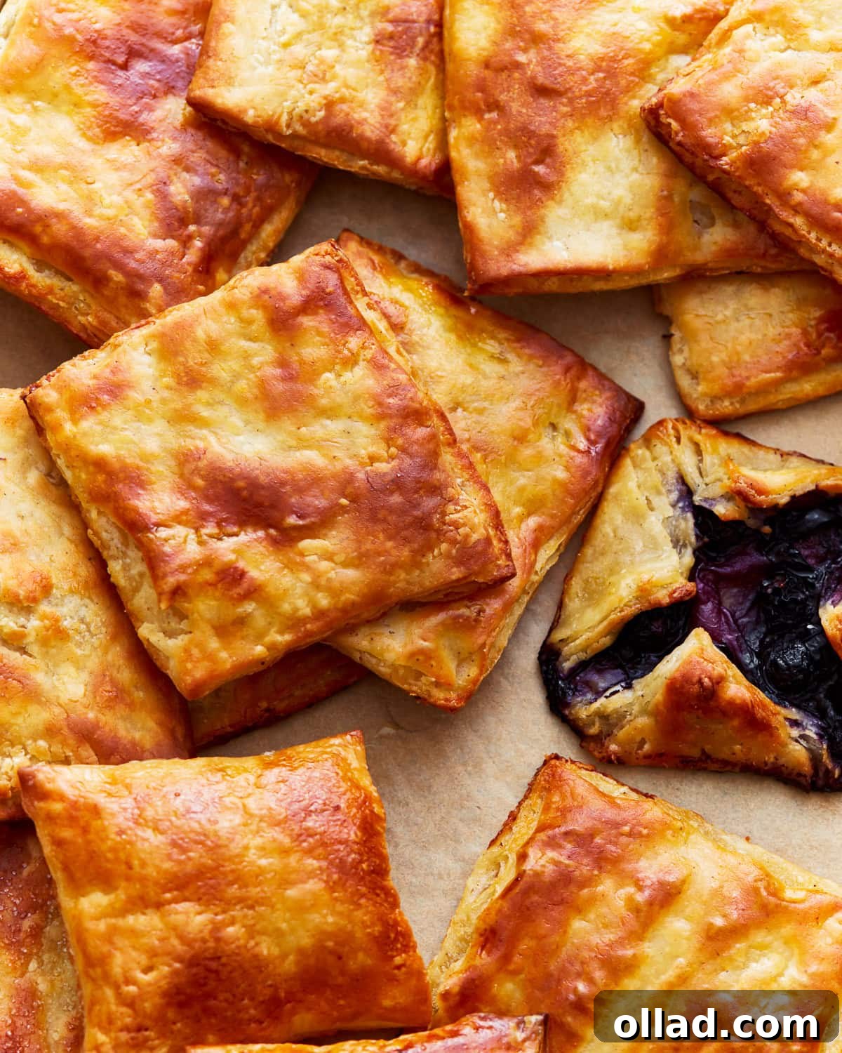 Unbelievably Flaky Gluten-Free Puff Pastry 20 An overhead shot of delicate gluten-free puff pastry squares arranged artfully with a rich Danish pastry, highlighting their golden finish.