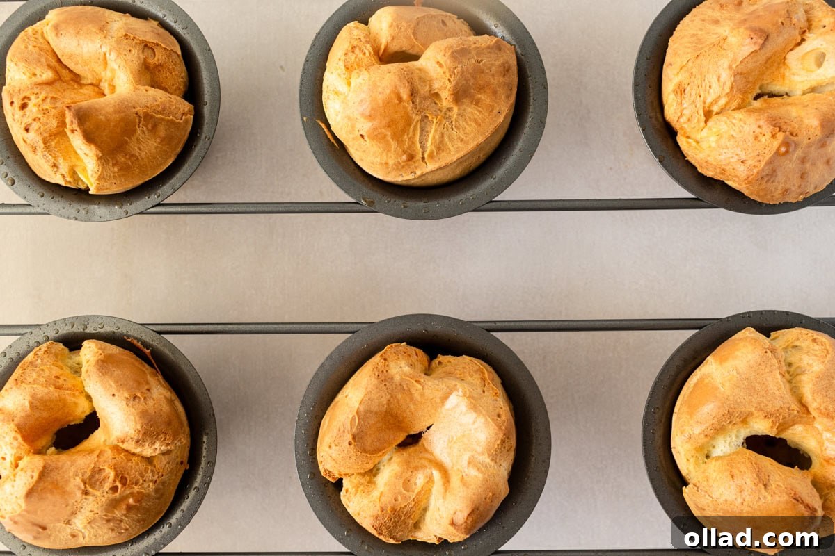 Overhead view of gluten-free popovers baking in a popover pan, showing their impressive rise.