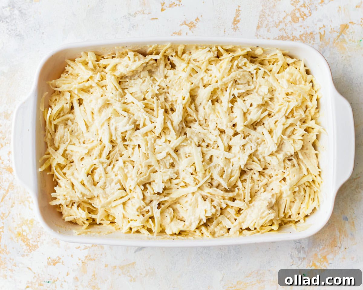 Grated potatoes with cashew sauce in a baking dish.