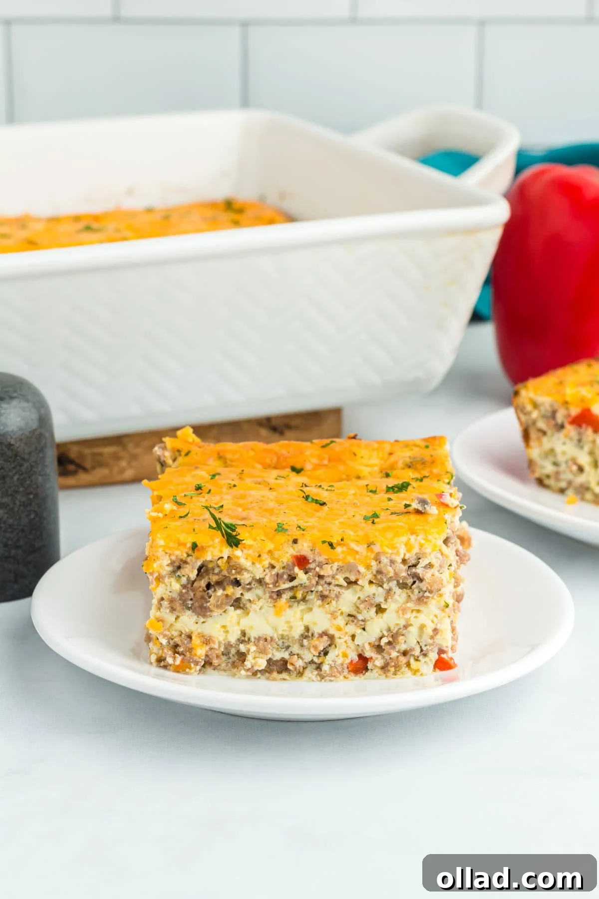 one piece of egg and sausage casserole on a white plate