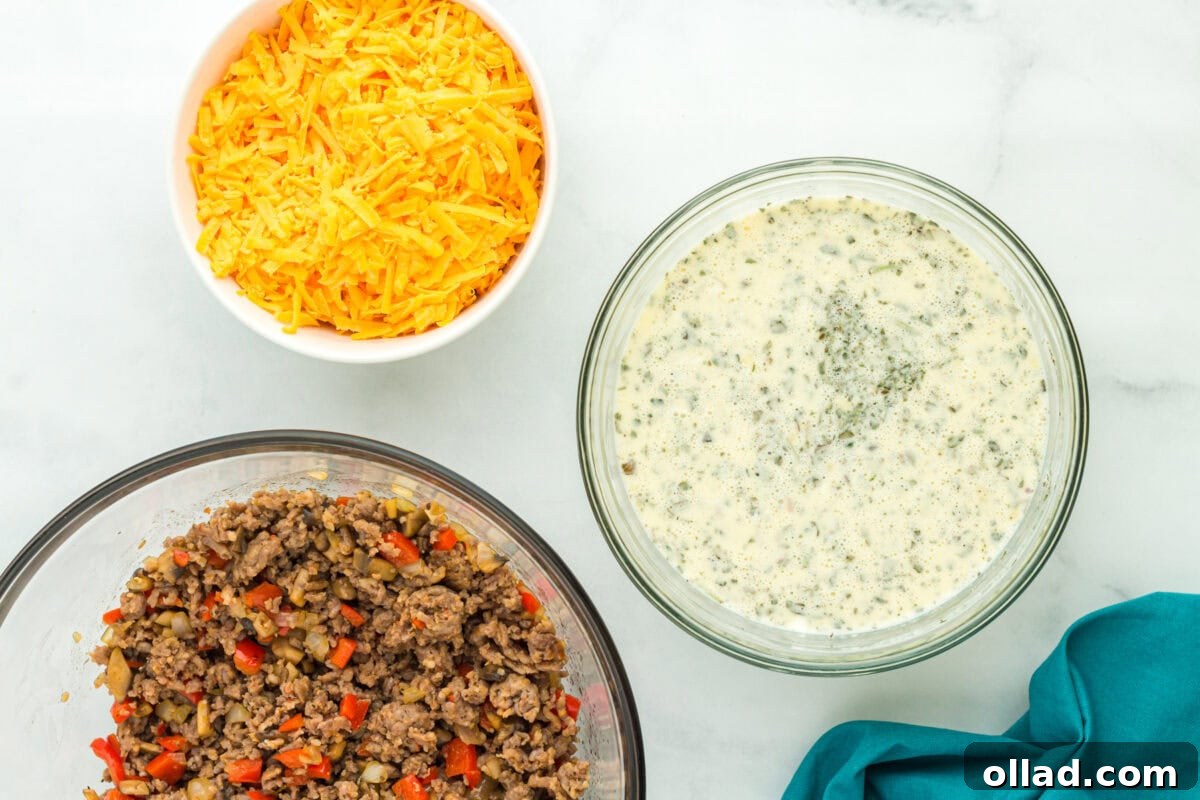 a bowl with sausage and veggies, a bowl with shredded cheese, a bowl with sour cream mixture