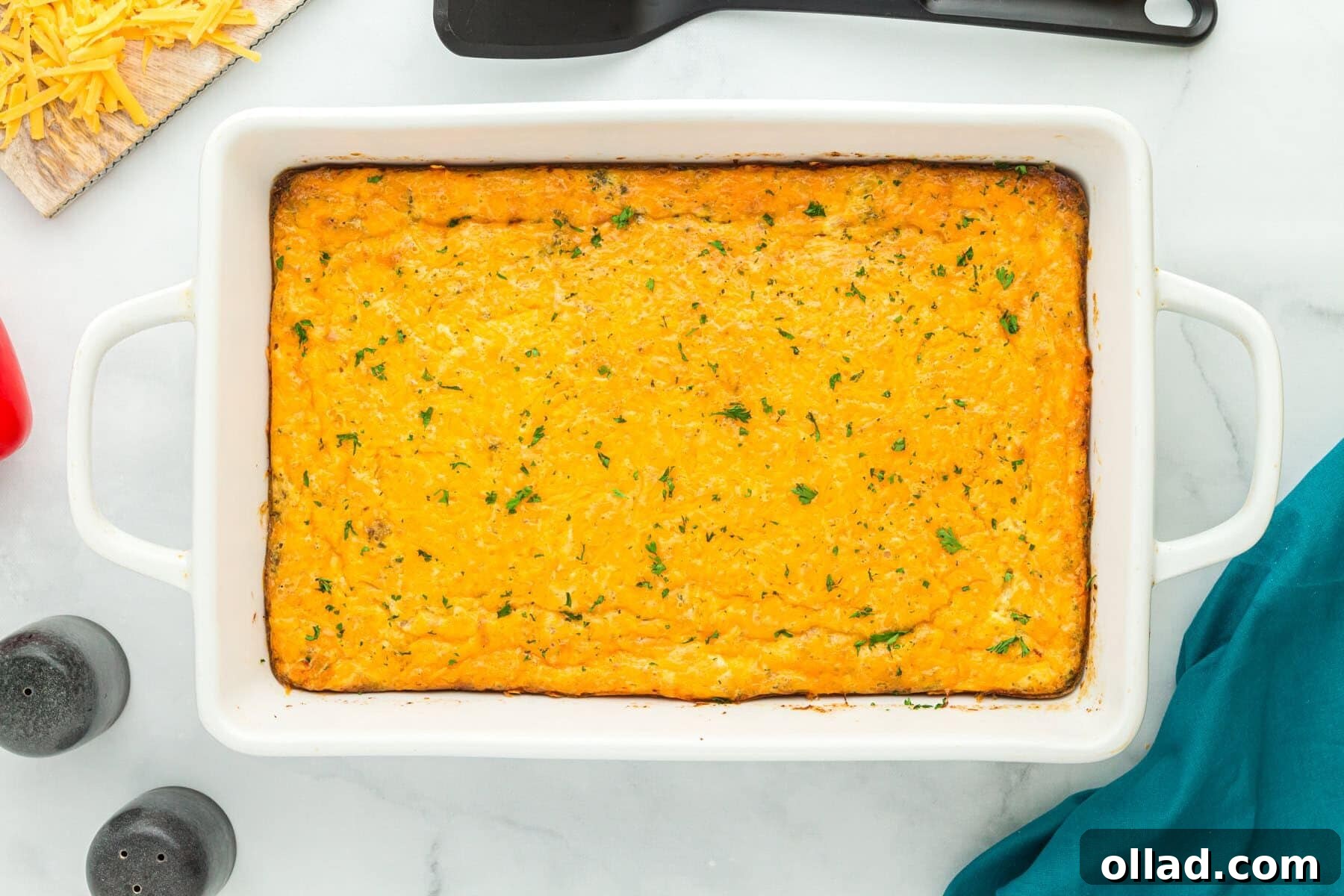 Overhead view of sausage and egg casserole in white baking dish